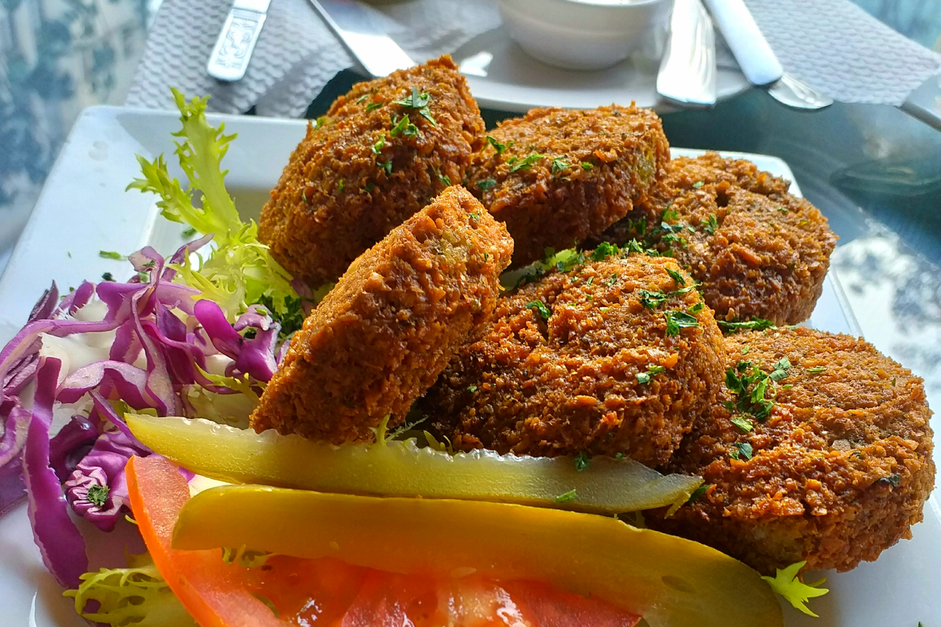 Plated falafel dish with garnish and salad